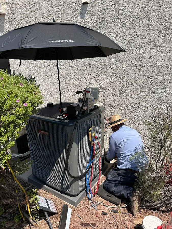HVAC technician performing outdoor AC maintenance in Stevensville